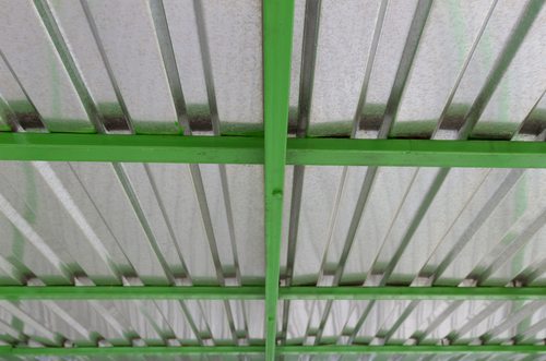 Overhead galvanized steel roof with green beams